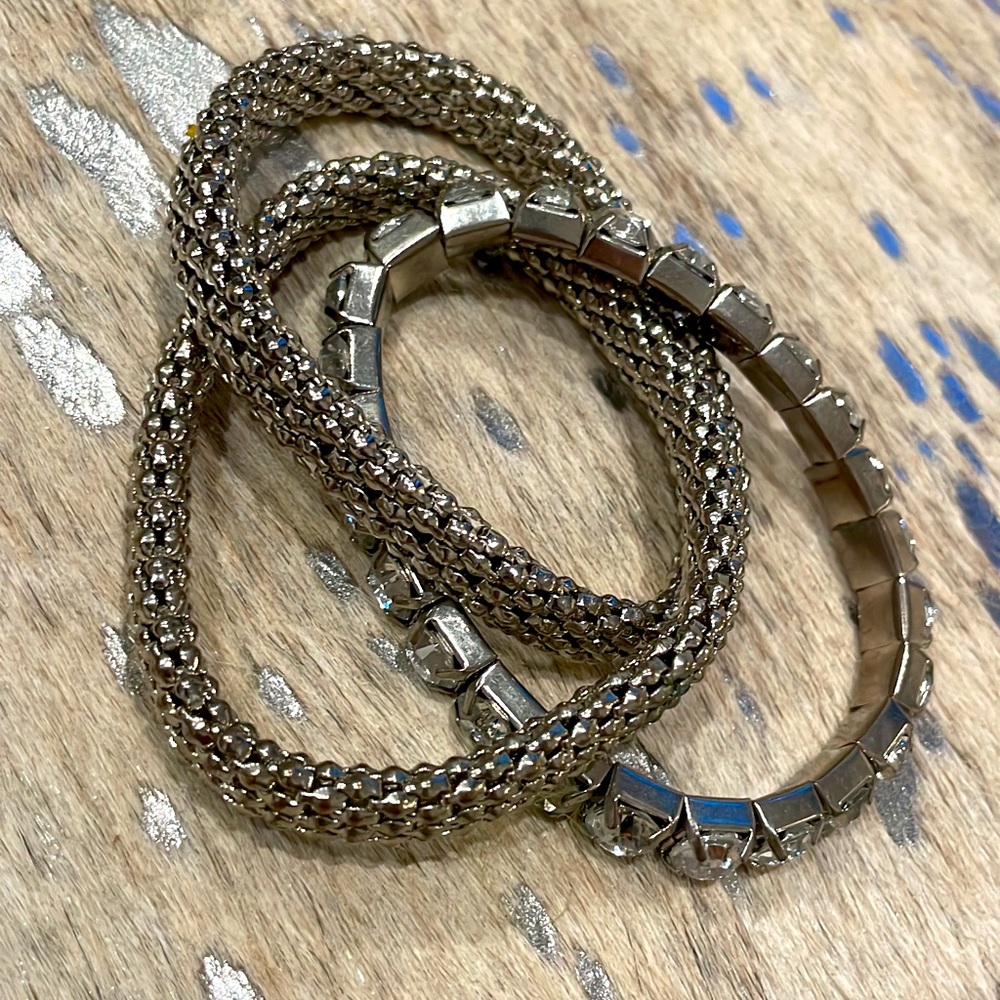 Silver colored set of three connected bracelets